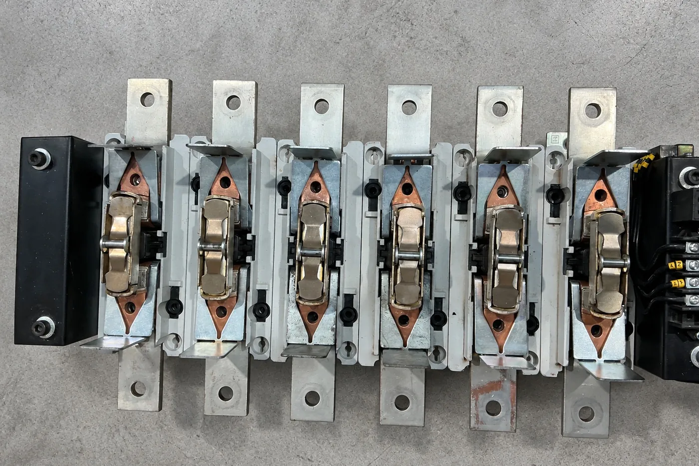 Six restored contactor pole assemblies with new silver contact tips and copper carriers